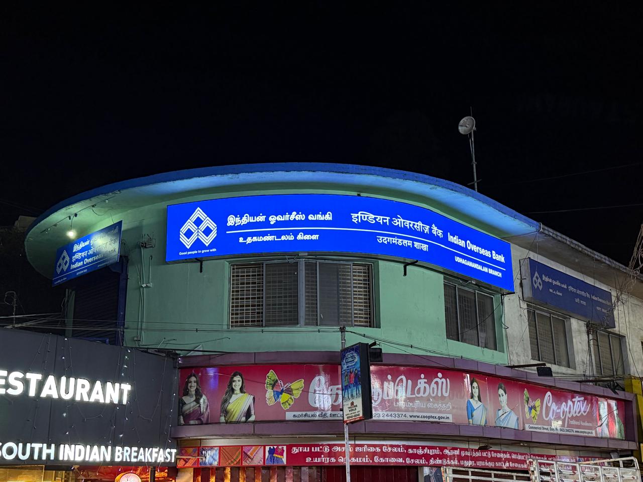 Indian Overseas Bank — Illuminated corner-building branch signage, by Choice Advertising